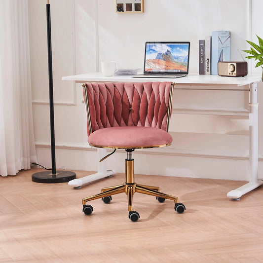 Elegant pink velvet ergonomic office chair with gold base in a modern workspace