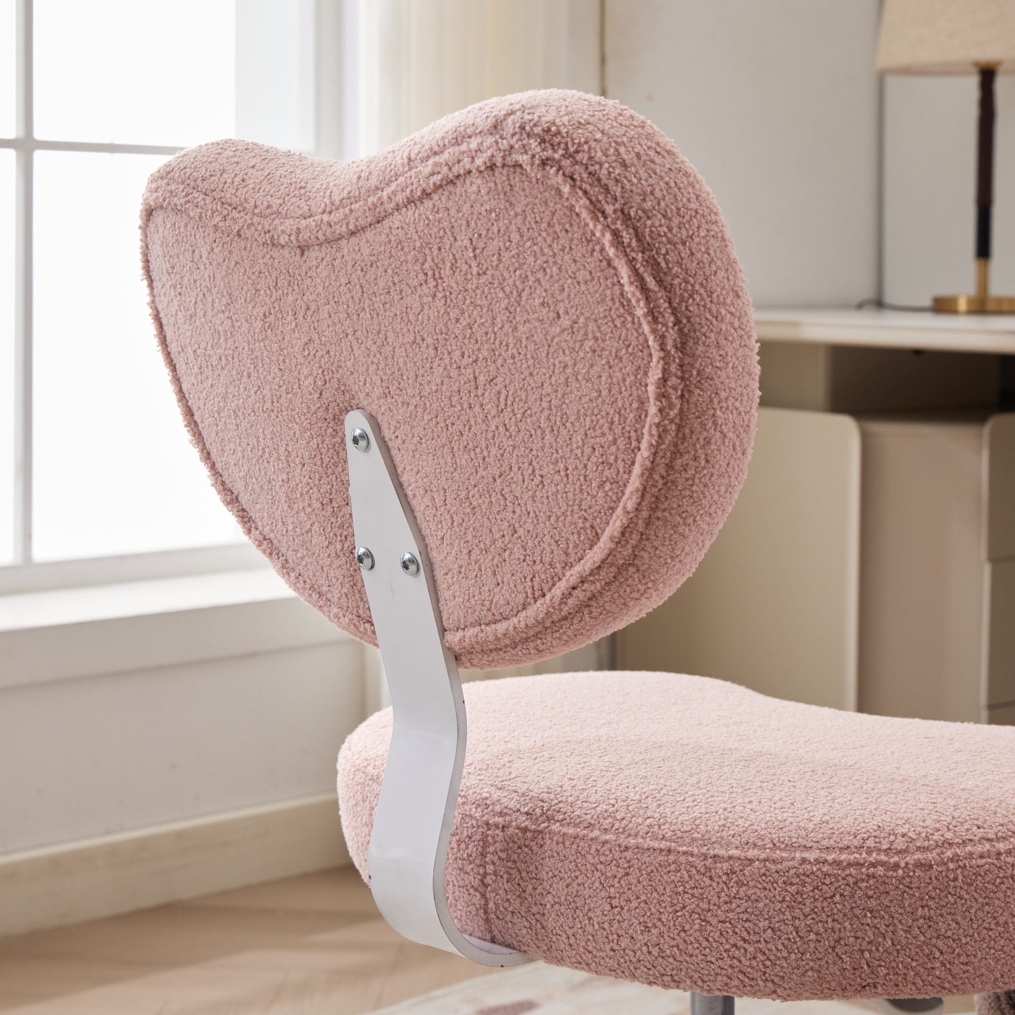 Pink plush meditation chair with curved back, cross-brace metal support, and built-in lumbar support.