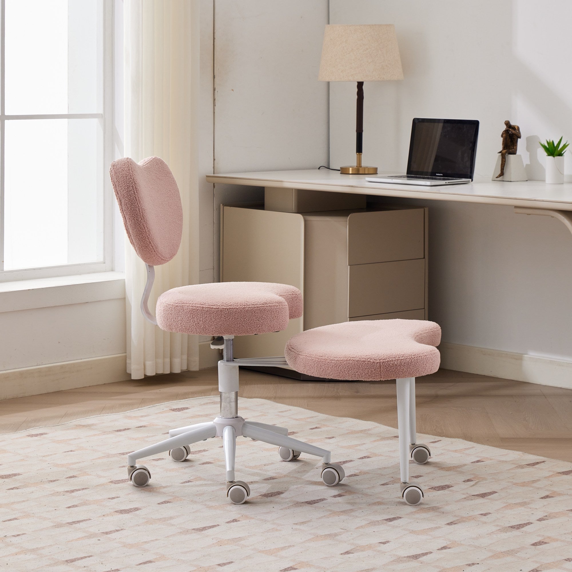 Pink cross-legged meditation chair with wheels, ADHD lumbar support, plus-size, and matching footrest in home office.