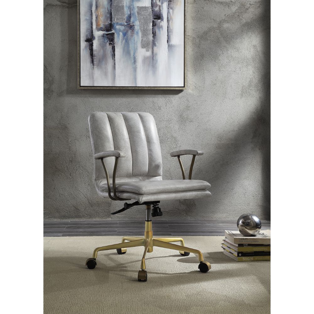Vintage white leather swivel office chair in room setting