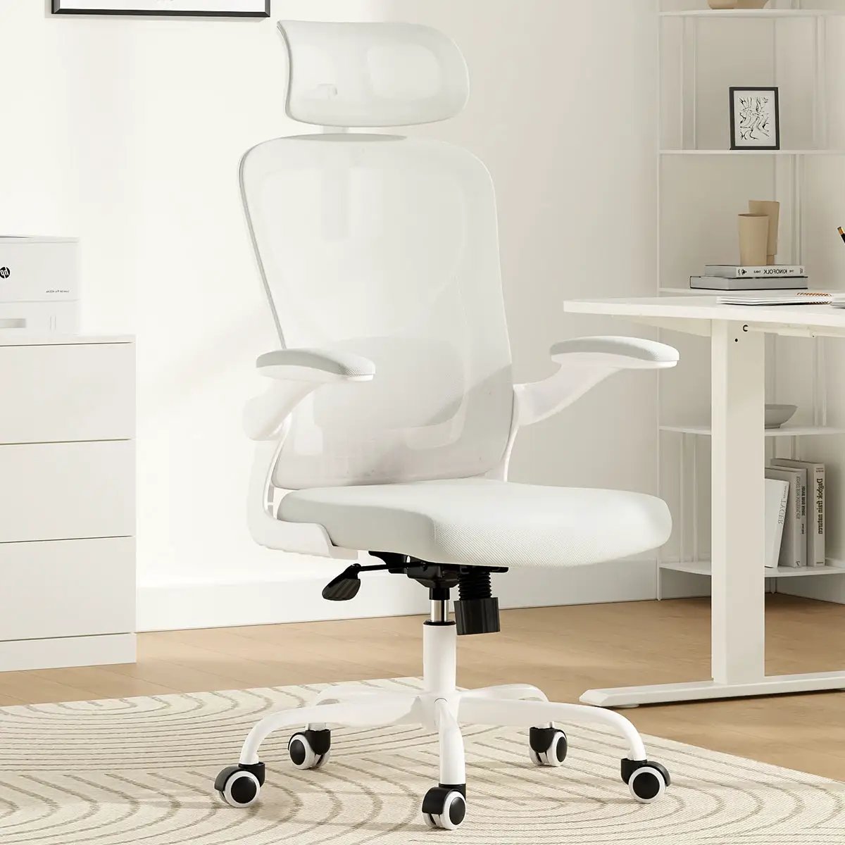 Ergonomic white office chair with headrest, mesh back, armrests, and adjustable lumbar support in a home office