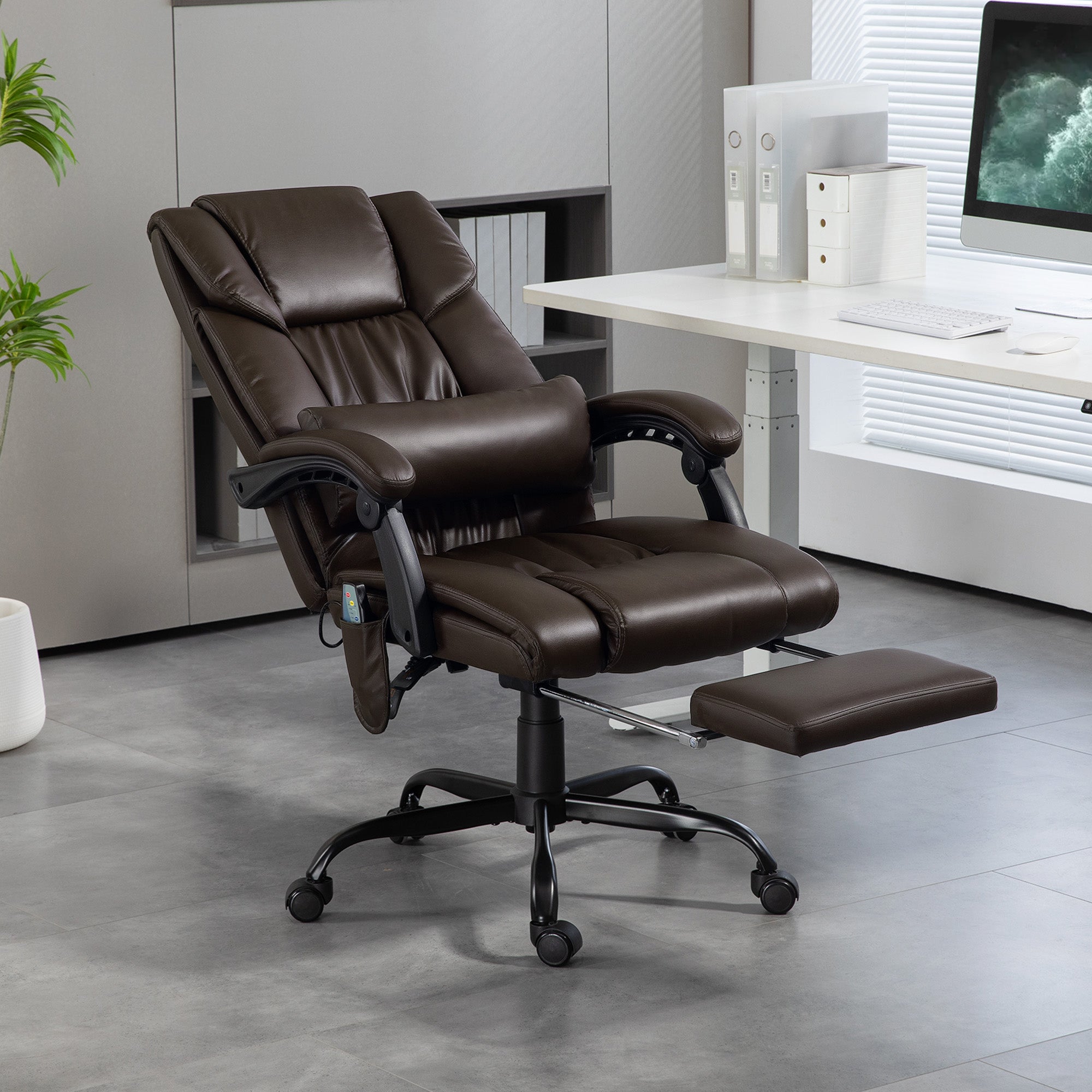 Brown massage office chair reclined with footrest extended in office