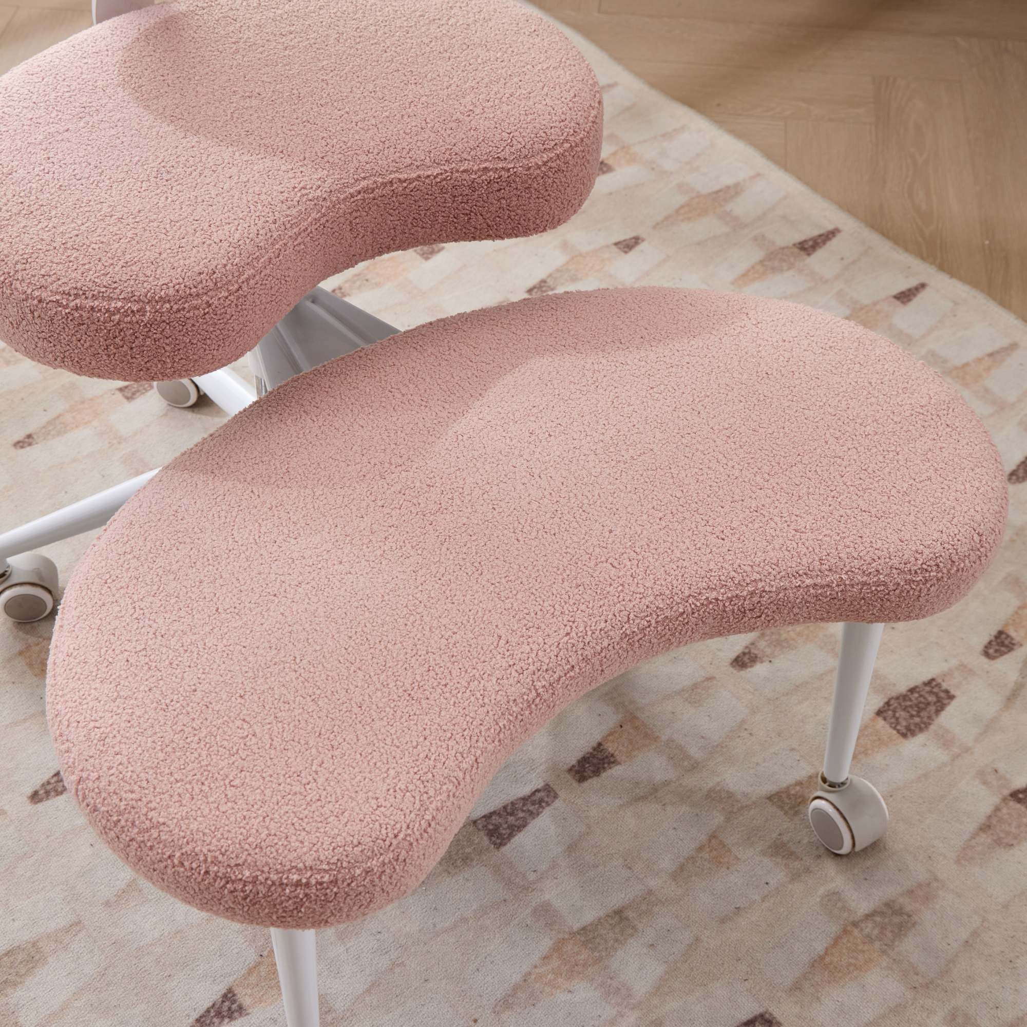 Pink cross-legged meditation chair with wheels, plush upholstery, and ADHD lumbar support.