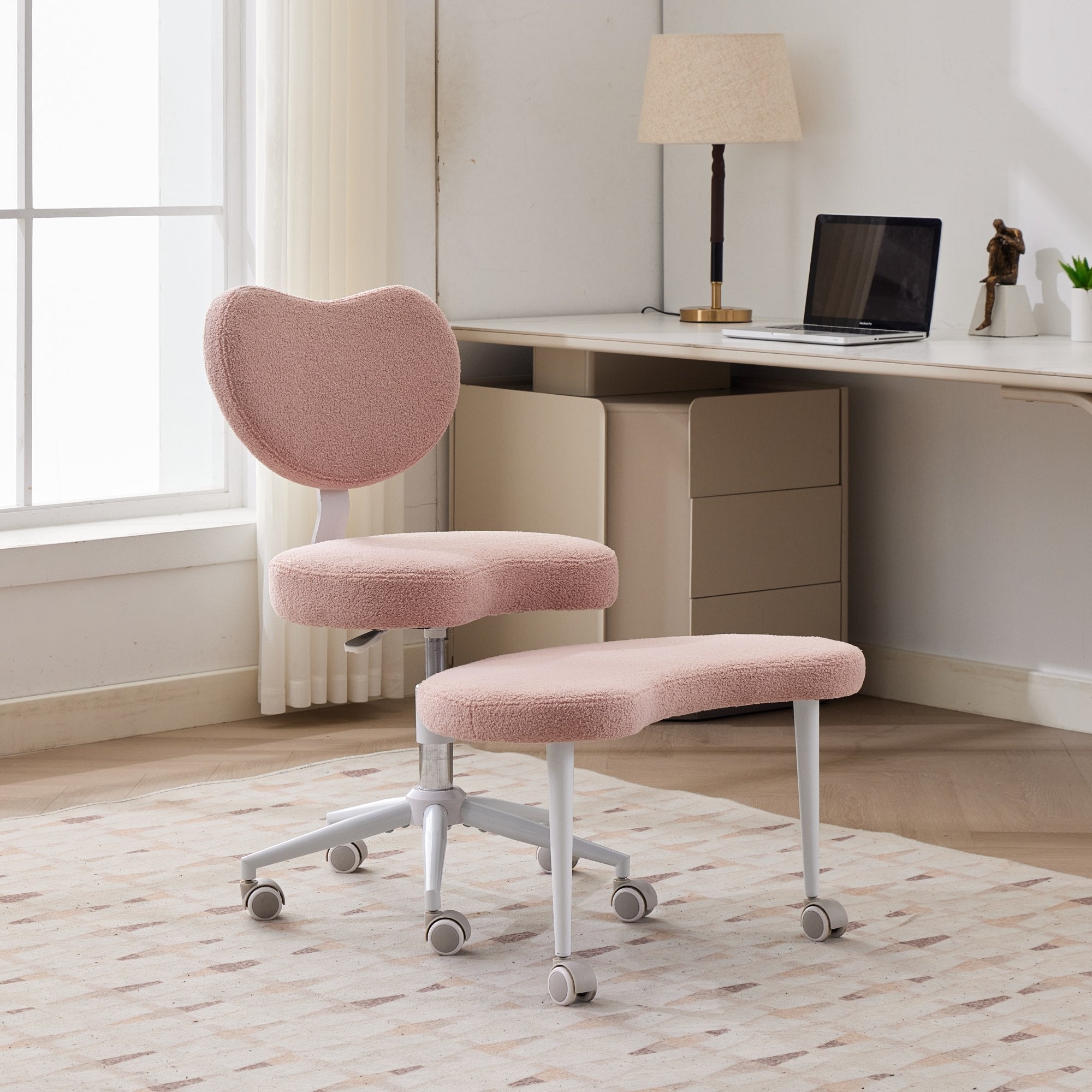Pink ADHD lumbar-support meditation chair with cross-legged design and wheels in a bright home office.