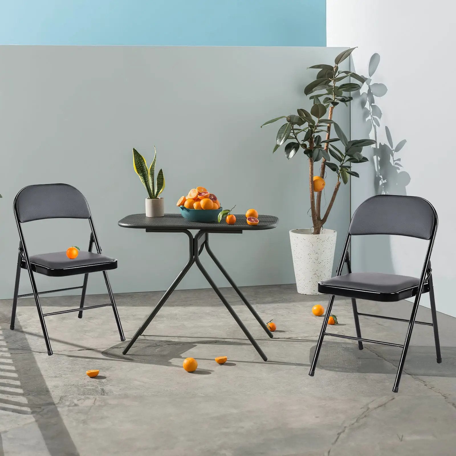 Set of two black CJDS folding chairs with sleek premium leather upholstery, designed for home use and comfortable seating.
