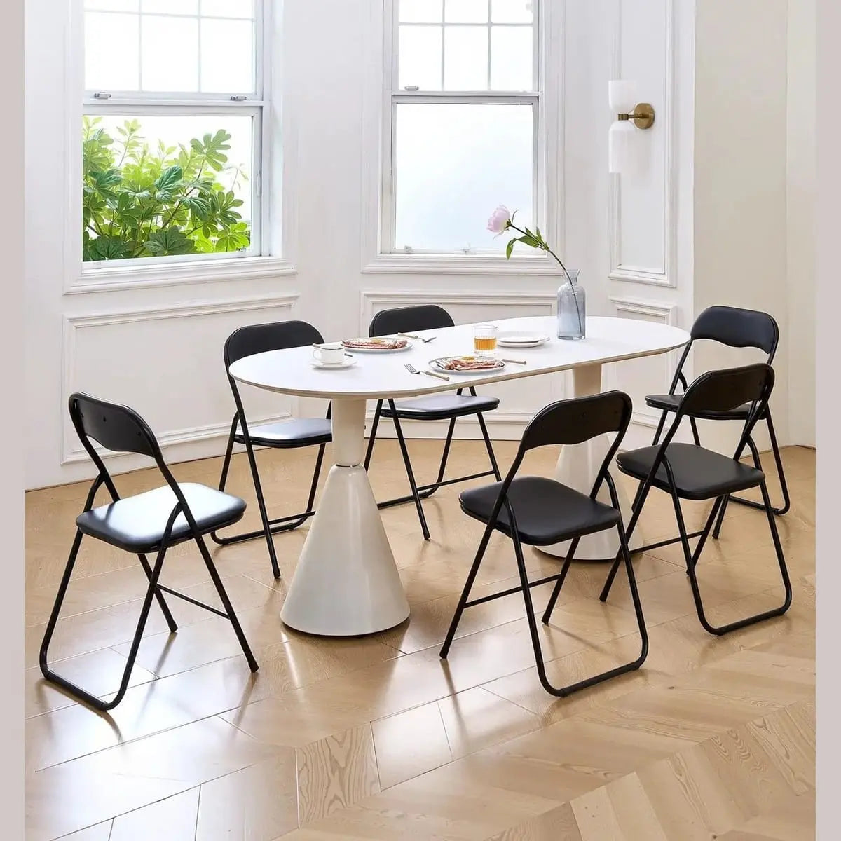 Black CJDS heavy-duty folding chairs with padded leather cushions, ideal for events and extra comfort.