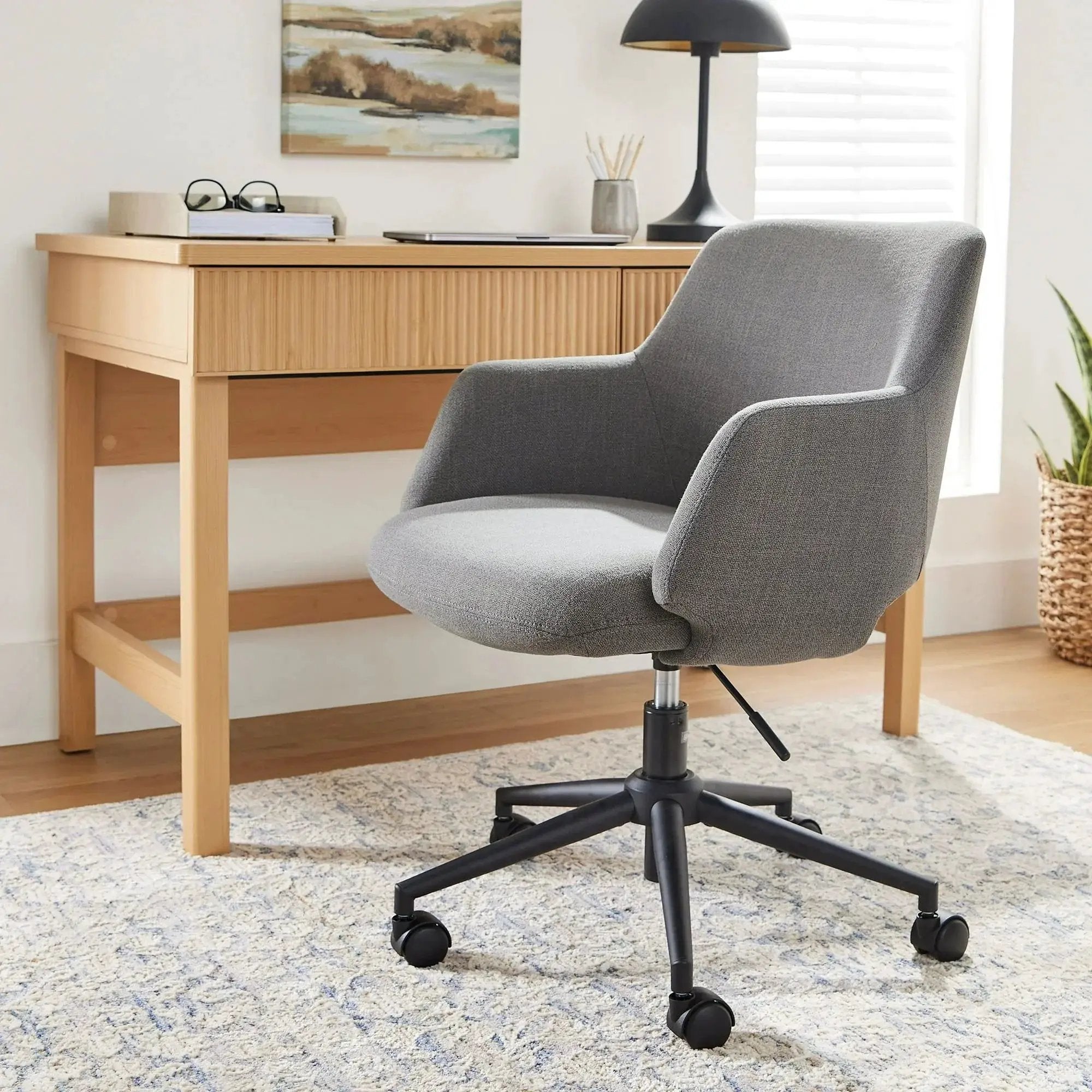 Doba Lillian ergonomic office chair with adjustable height, black mesh back, cushioned seat, and armrests for home office comfort.