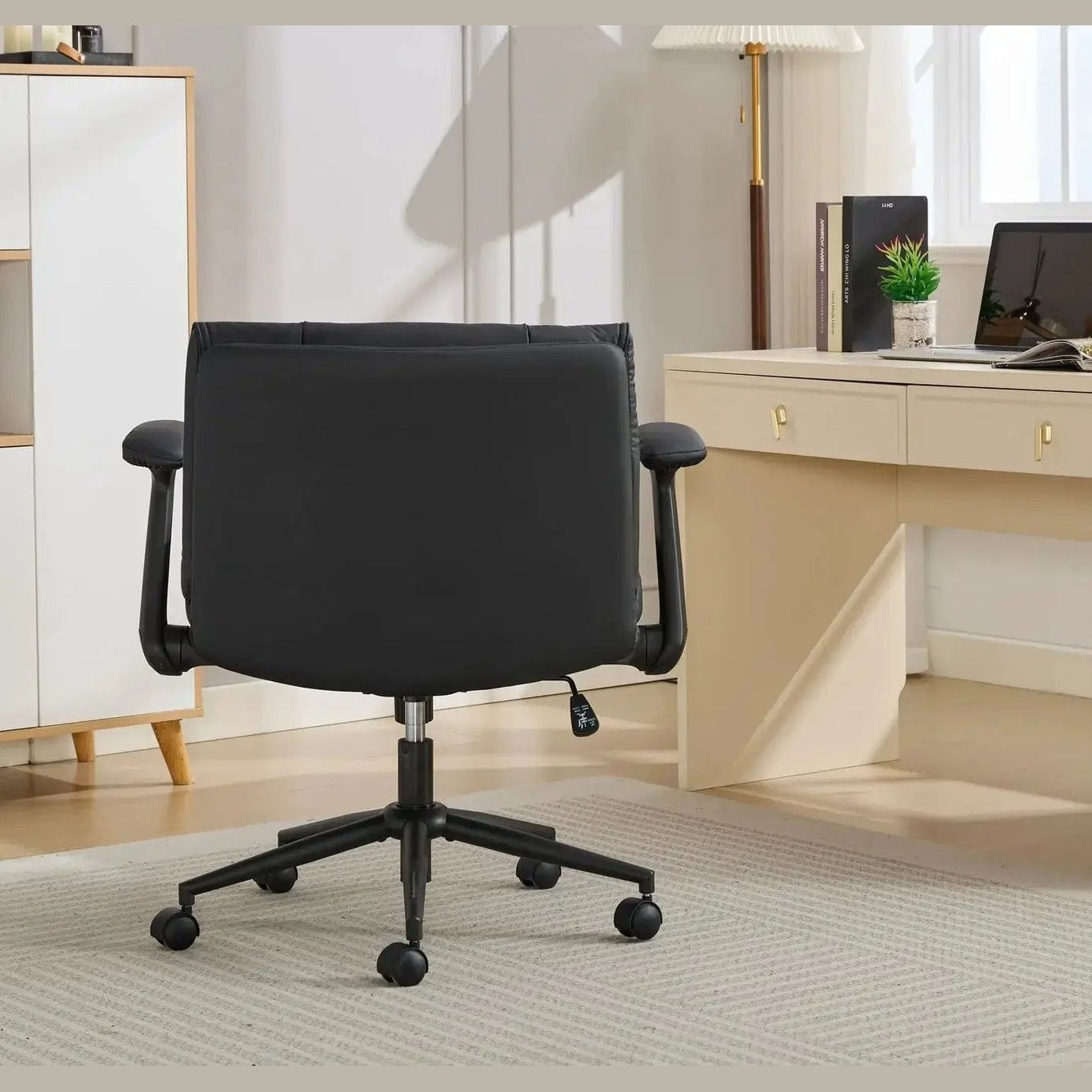 Black Doba ergonomic leather crisscross office chair with flip-up armrests and wheels, designed for comfort and mobility.
