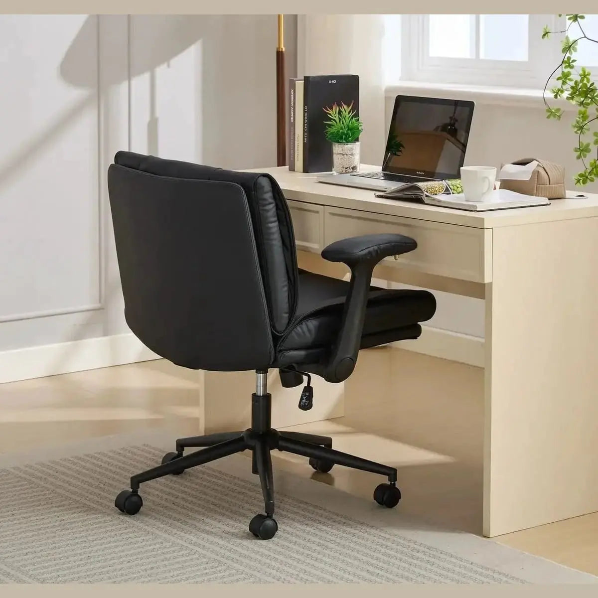 Black Doba ergonomic leather crisscross chair with flip-up armrests and wheels, designed for comfort and mobility.
