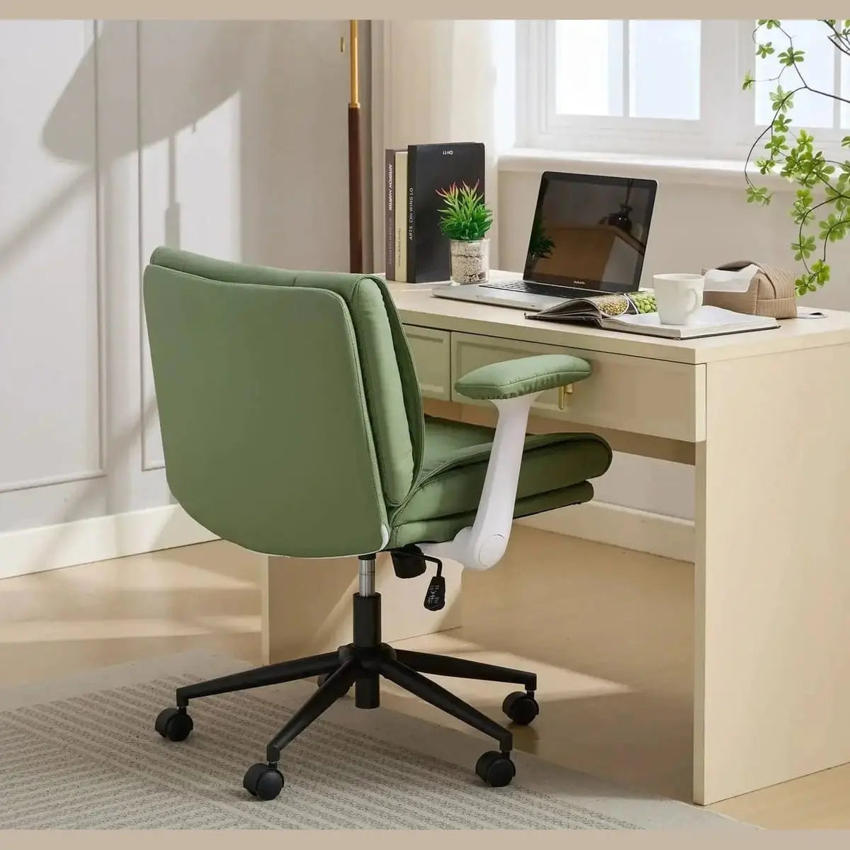 Black Doba ergonomic leather crisscross office chair with flip-up armrests and wheels, designed for comfortable seating and mobility.