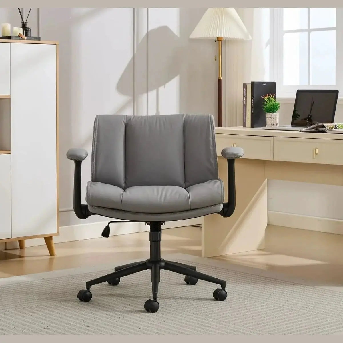 Doba black ergonomic leather crisscross office chair with flip-up armrests and wheels, designed for comfort and mobility.