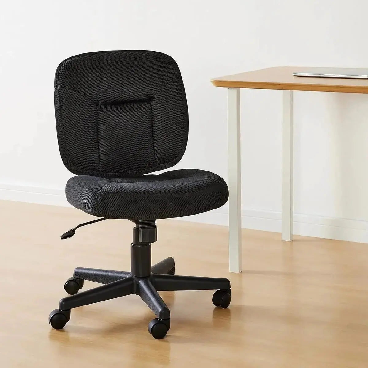 Black Doba ergonomic low back office chair with height adjustment and 360-degree swivel, featuring padded seat and adjustable support.