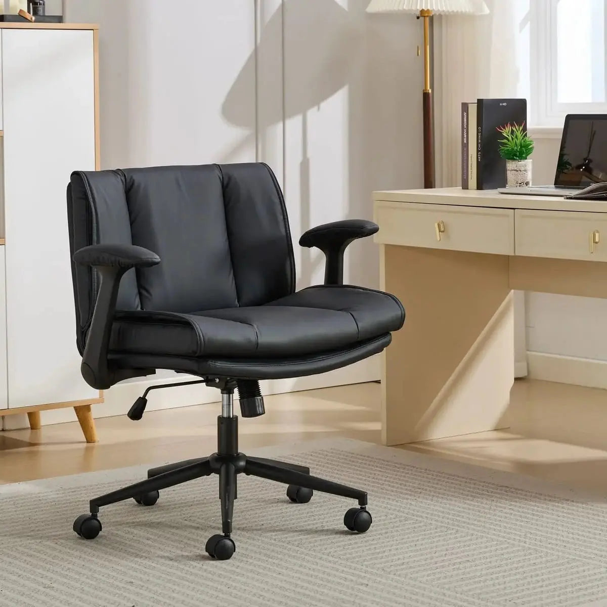 Doba black leather ergonomic cross-legged chair with adjustable flip-up armrests and metal frame, designed for comfort and support.