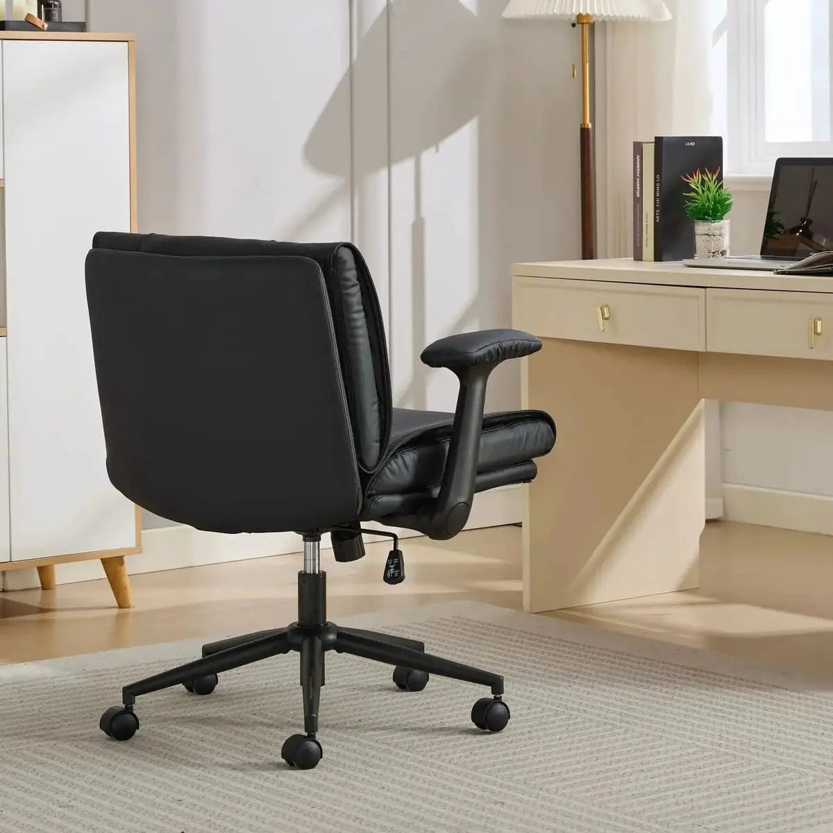Doba ergonomic black leather cross-legged chair with adjustable flip-up armrests and black metal frame.