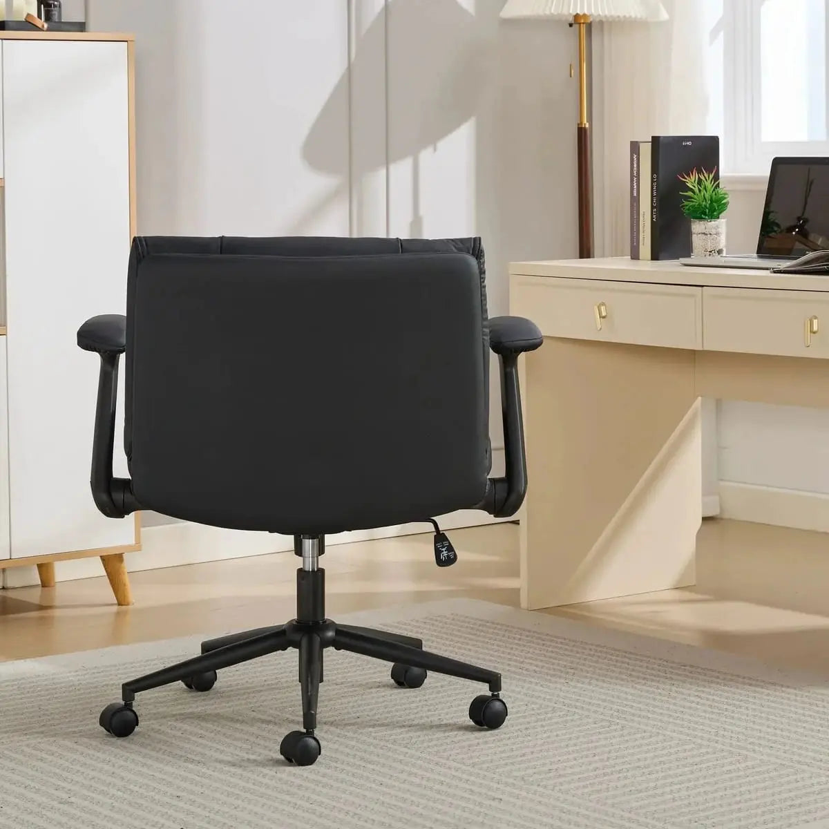 Black leather ergonomic cross-legged chair by Doba with adjustable flip-up armrests and metal frame.