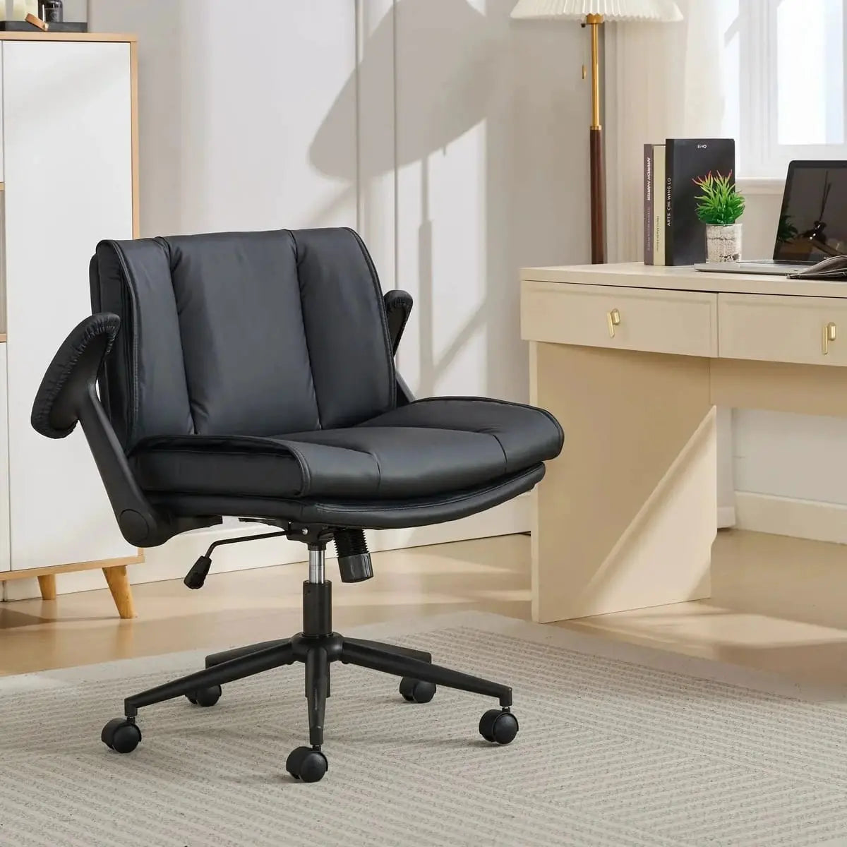 Doba ergonomic leather cross-legged chair with black metal frame, adjustable flip-up armrests, and cushioned seating.