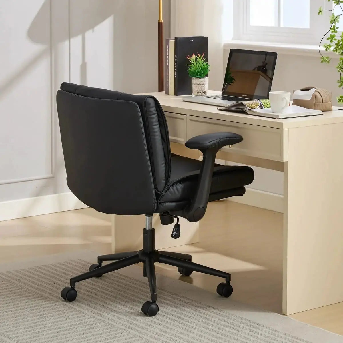 Doba ergonomic black leather cross-legged chair with adjustable flip-up armrests and black metal frame, featuring a comfortable, modern design.