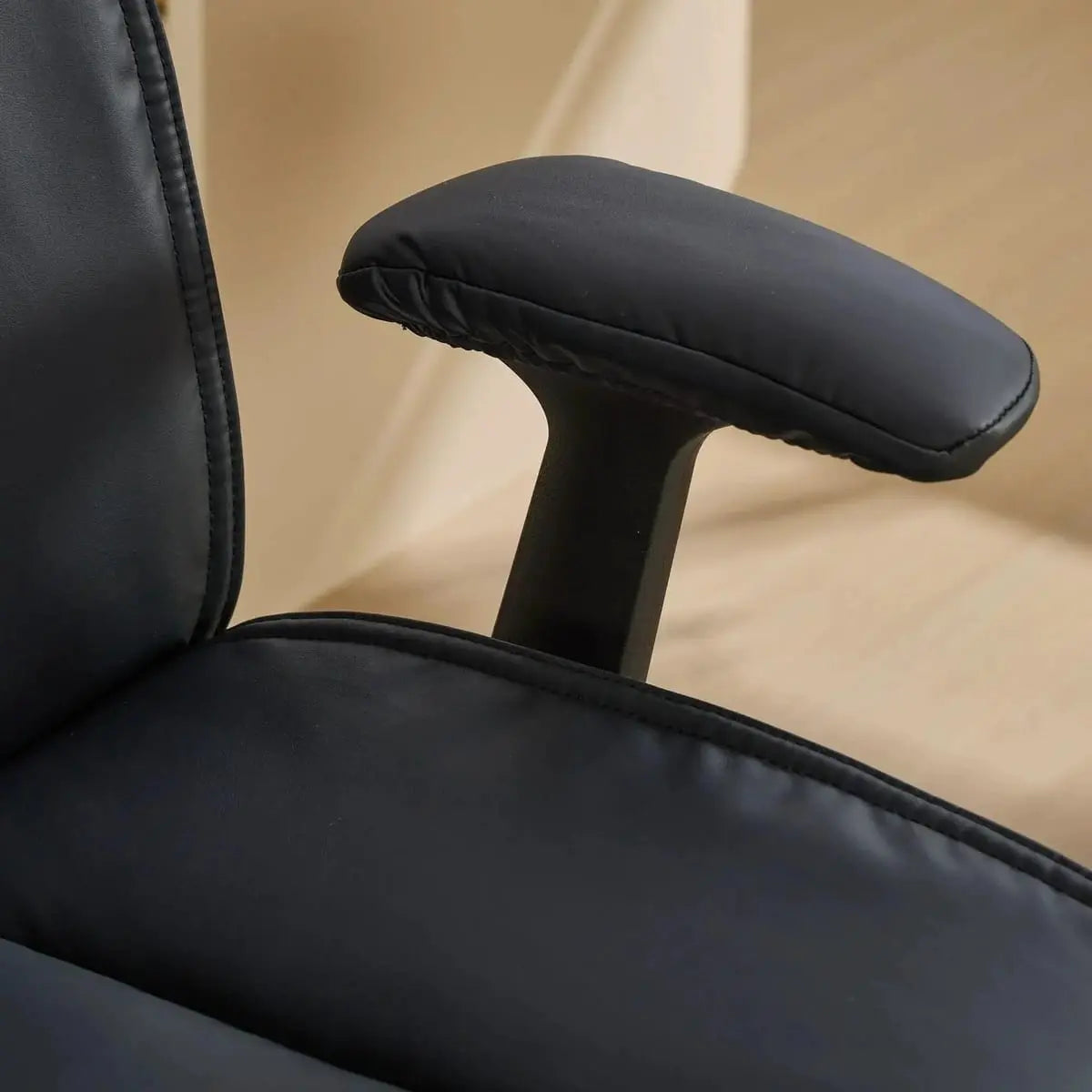Doba ergonomic black leather cross-legged chair with adjustable flip-up armrests and black metal frame, designed for comfort and style.