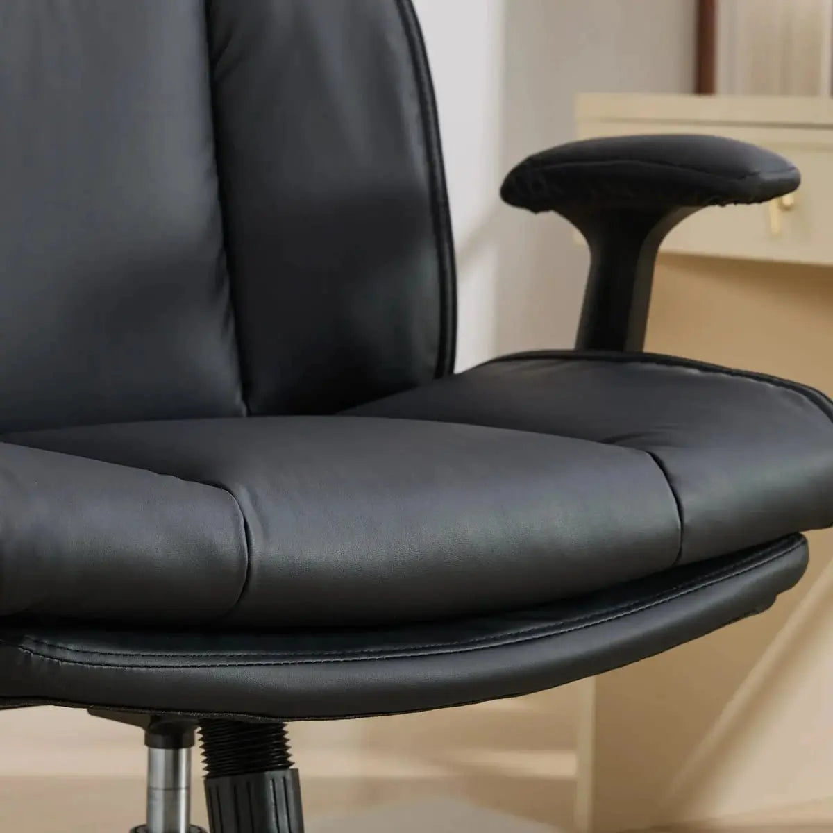 Black Doba ergonomic leather cross-legged chair with adjustable flip-up armrests and metal frame for comfortable seating.