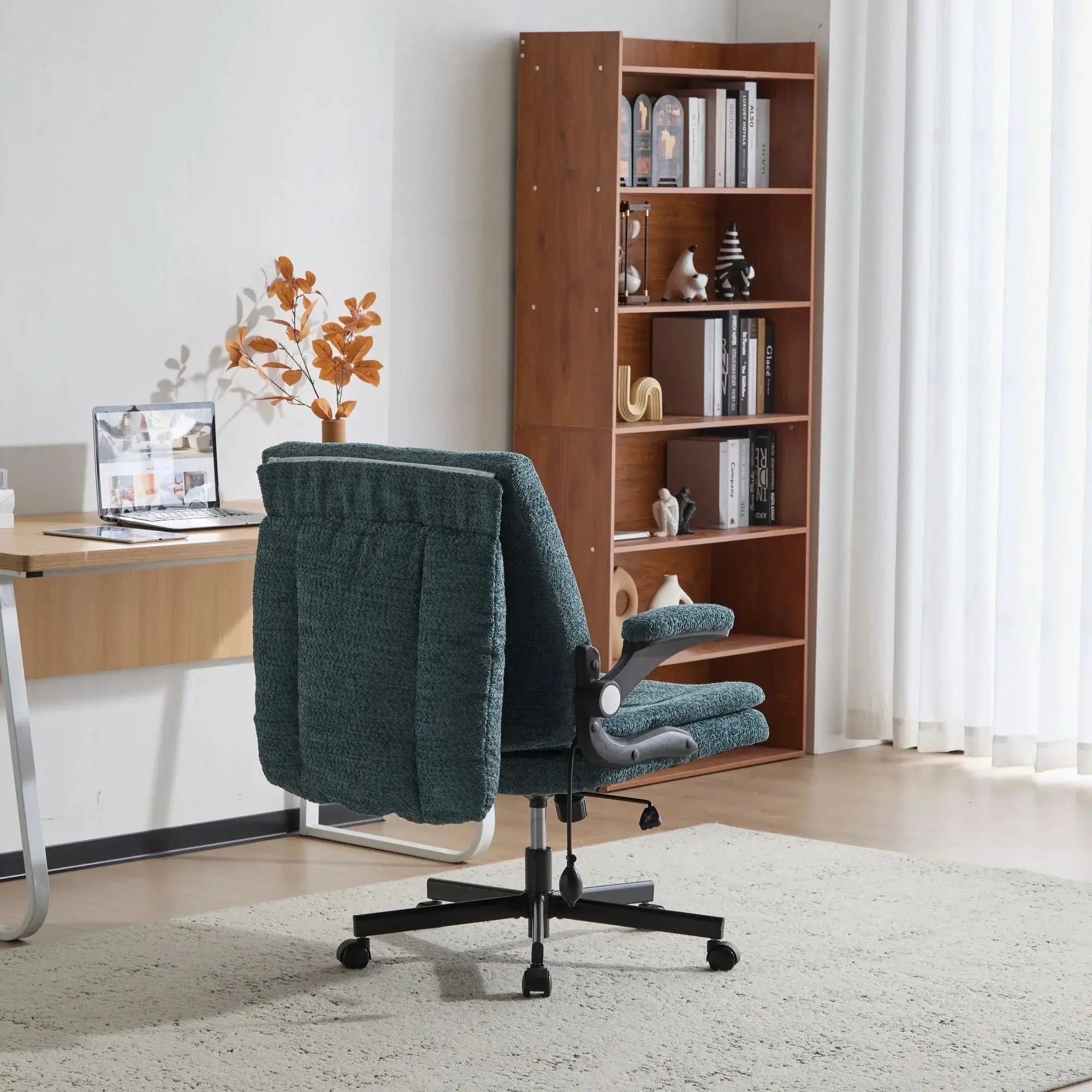 Dark green Doba ergonomic office chair with criss-cross design, airbag lumbar support, wide 25-inch seat, and adjustable flip-up armrests.