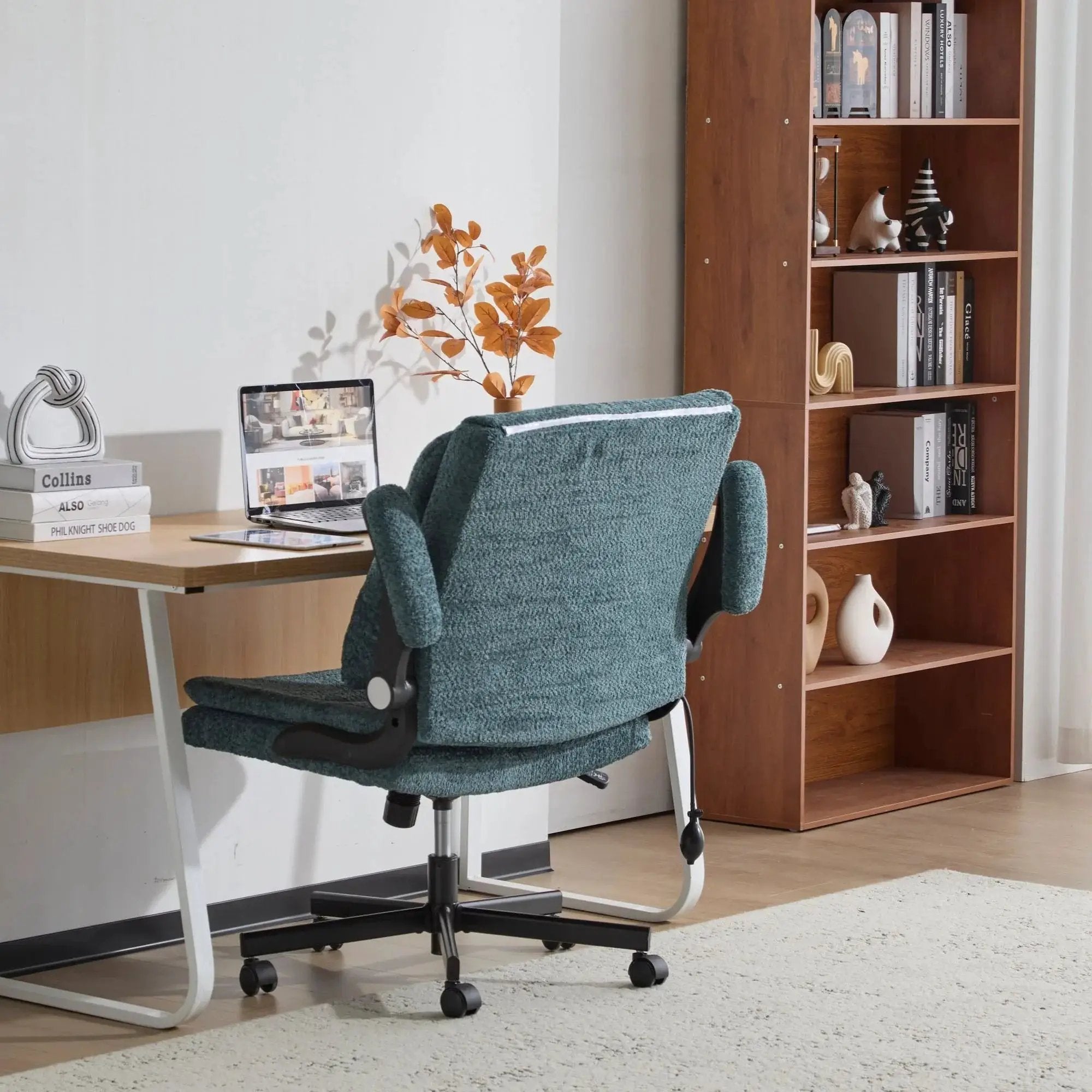 Dark green Doba ergonomic office chair with criss-cross design, airbag lumbar support, wide 25-inch seat, and adjustable flip-up armrests.