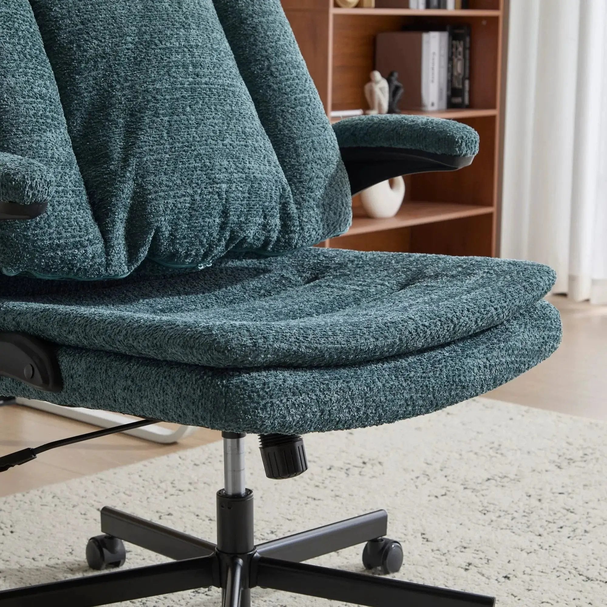 Dark green Doba ergonomic office chair with criss-cross design, airbag lumbar support, wide 25-inch seat, and flip-up armrests.