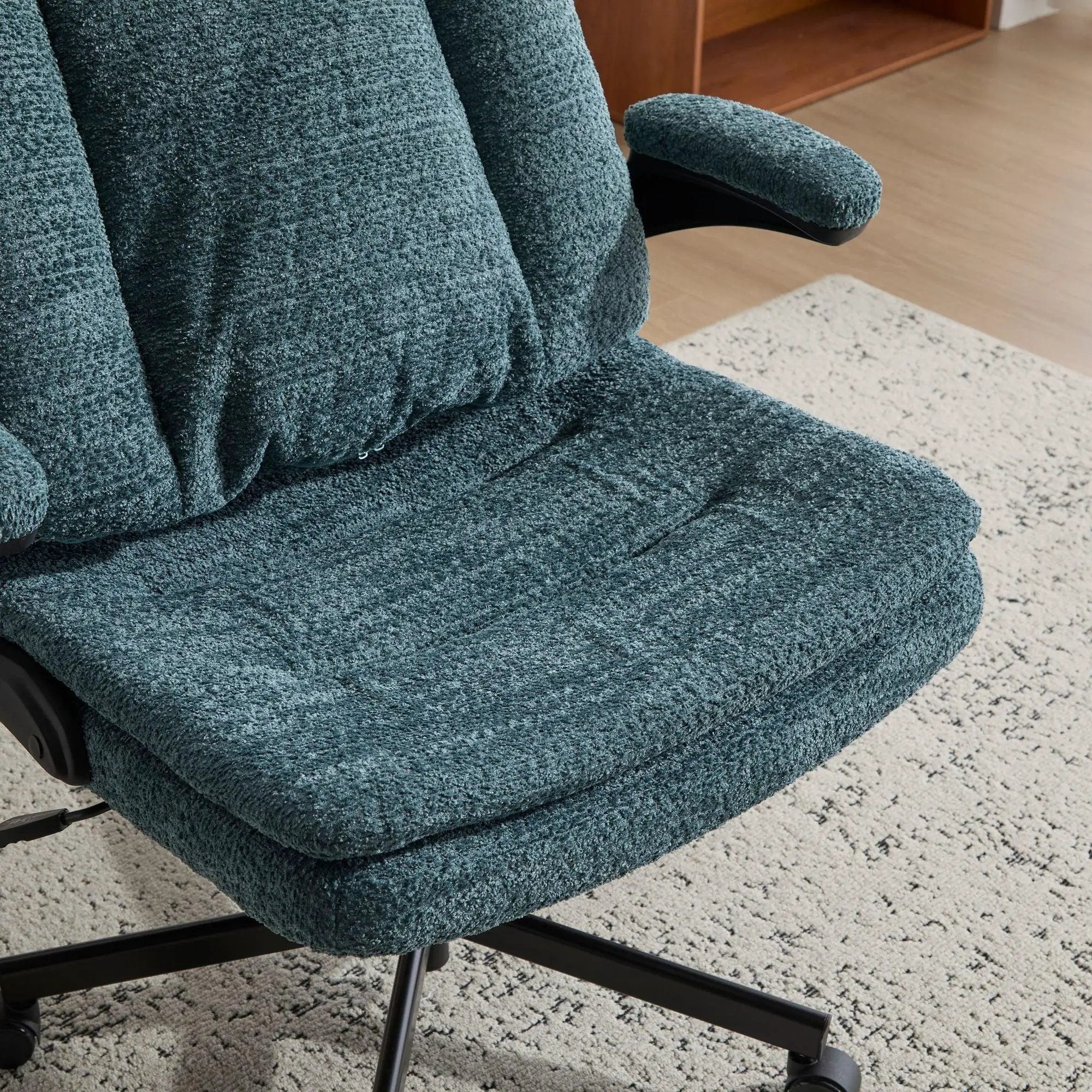 Dark green ergonomic Doba office chair with criss-cross design, airbag lumbar support, 25-inch seat, and adjustable flip-up armrests.