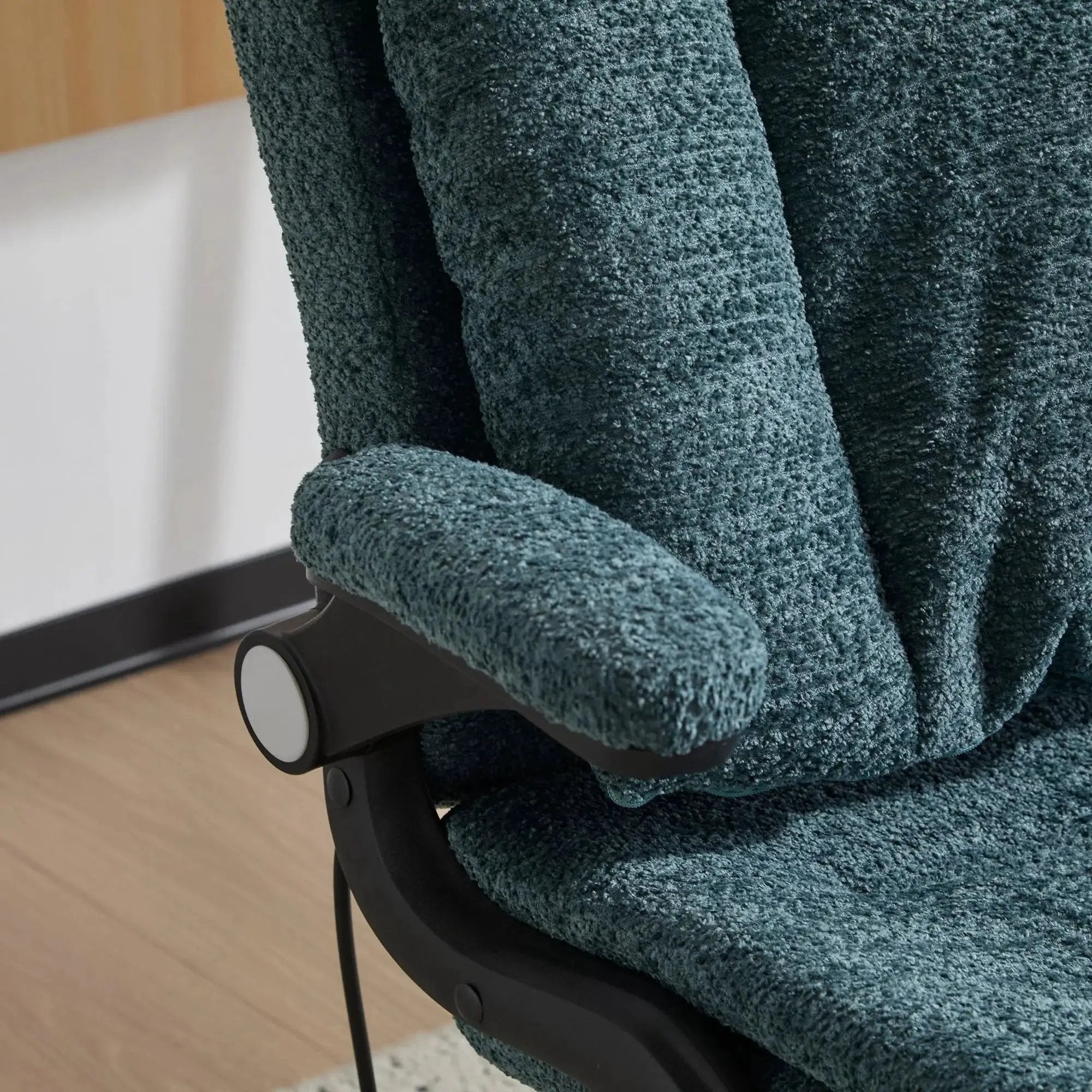 Dark green Doba ergonomic office chair with criss-cross design, airbag lumbar support, wide 25-inch seat, and adjustable flip-up armrests.