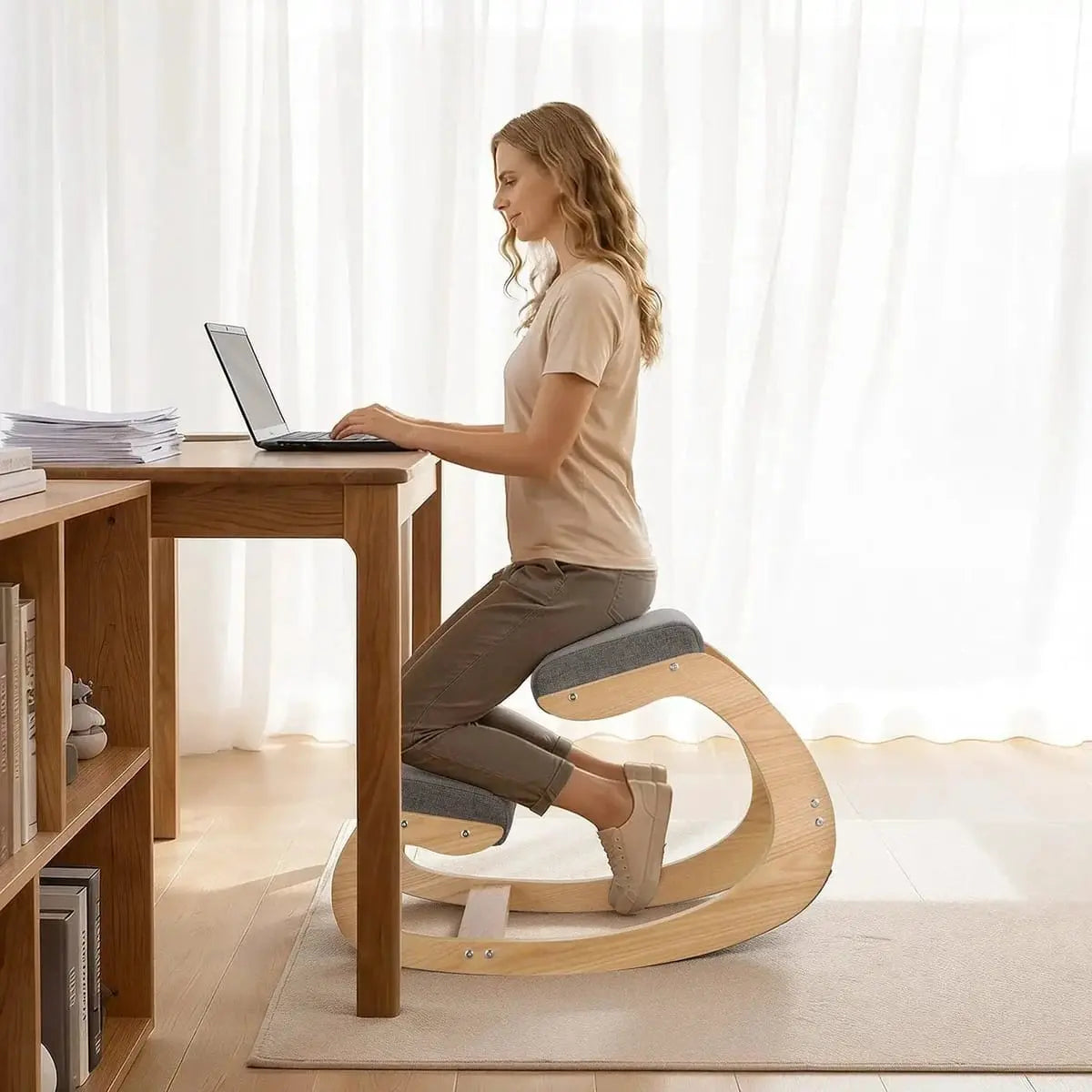Gray Doba ergonomic kneeling chair with wooden frame and rocking base, adjustable height for improved posture and back relief.