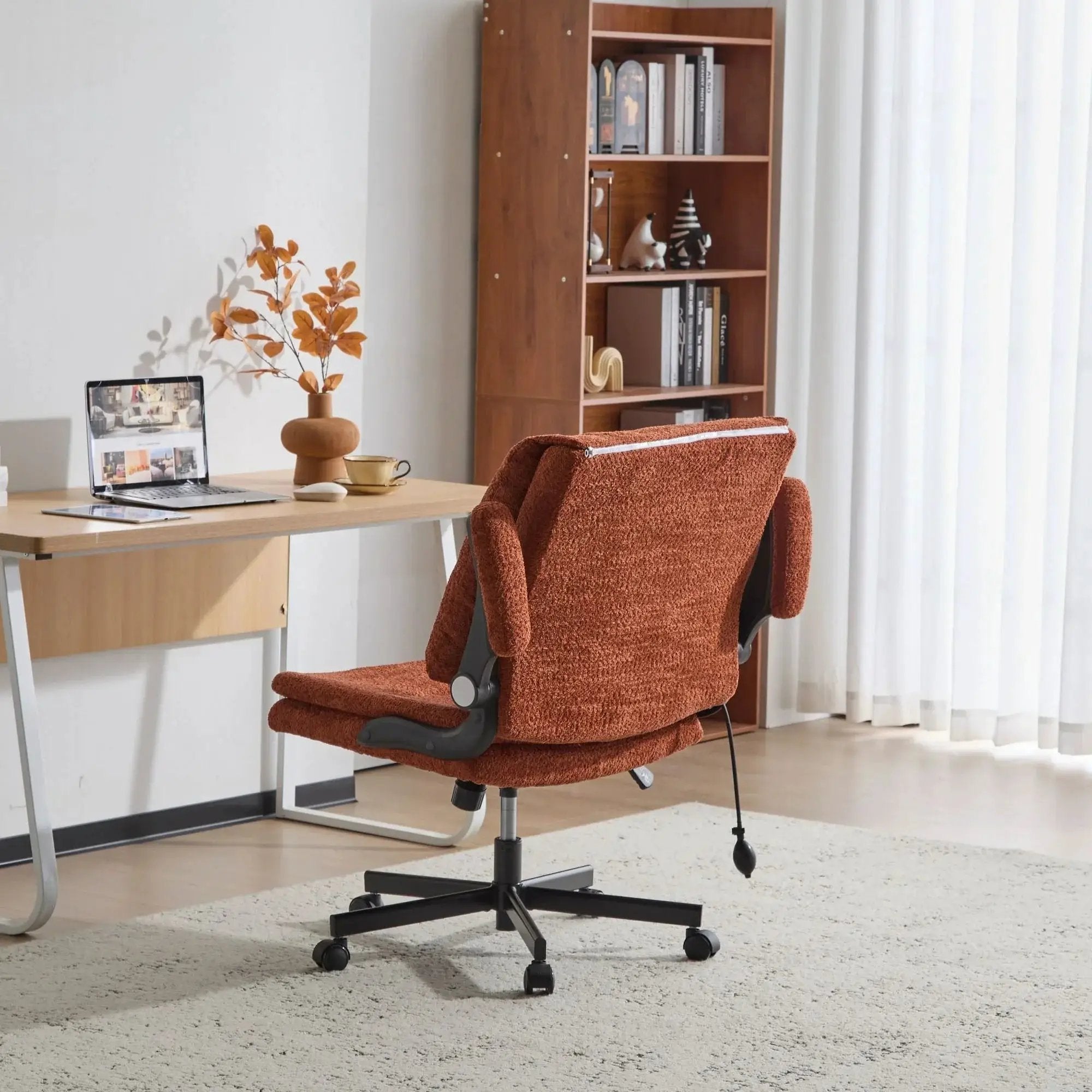 Doba orange ergonomic criss-cross desk chair with flip-up back and armrests, featuring nylon upholstery and adjustable design.