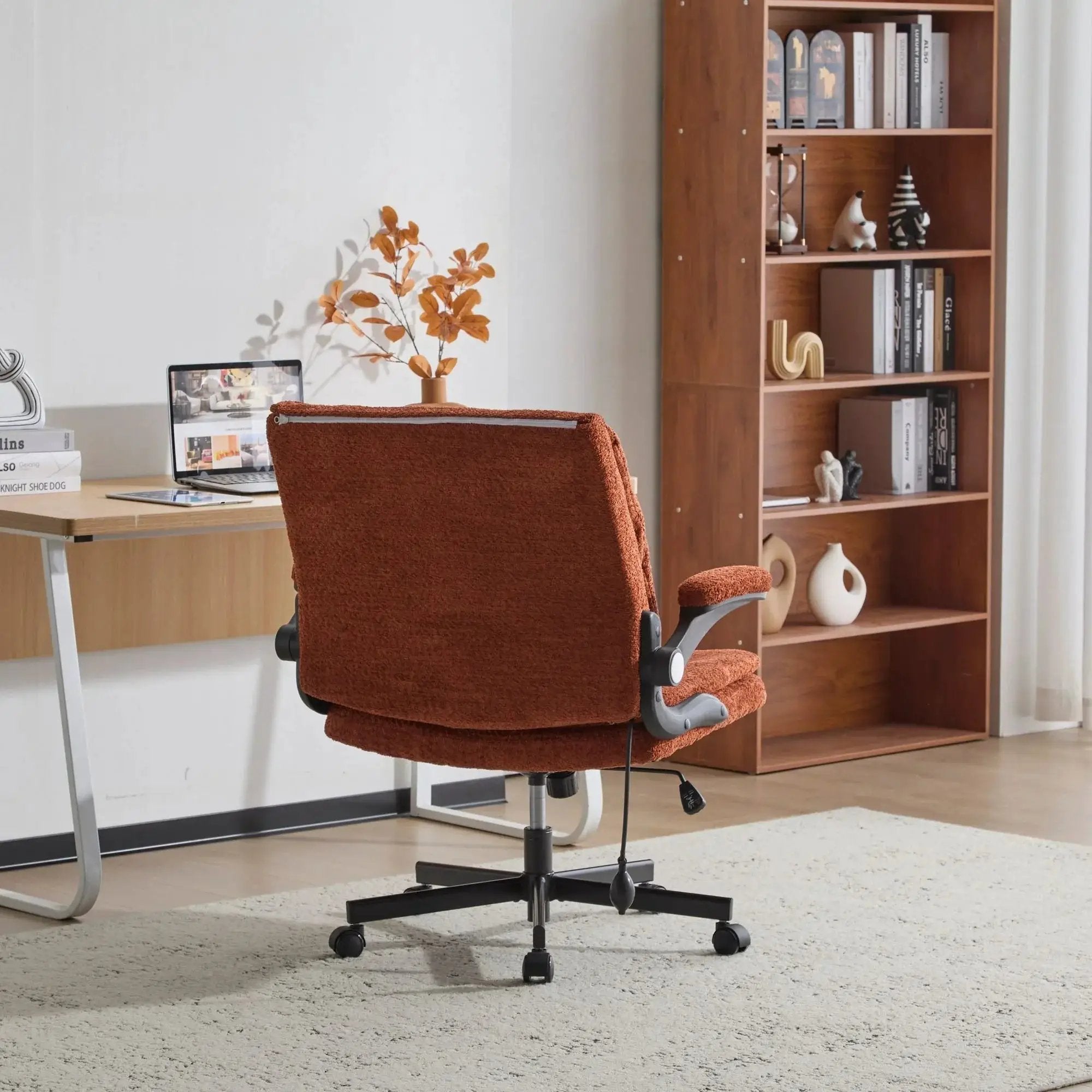 Doba orange ergonomic criss-cross desk chair with flip-up back and arms, featuring nylon upholstery and adjustable design.