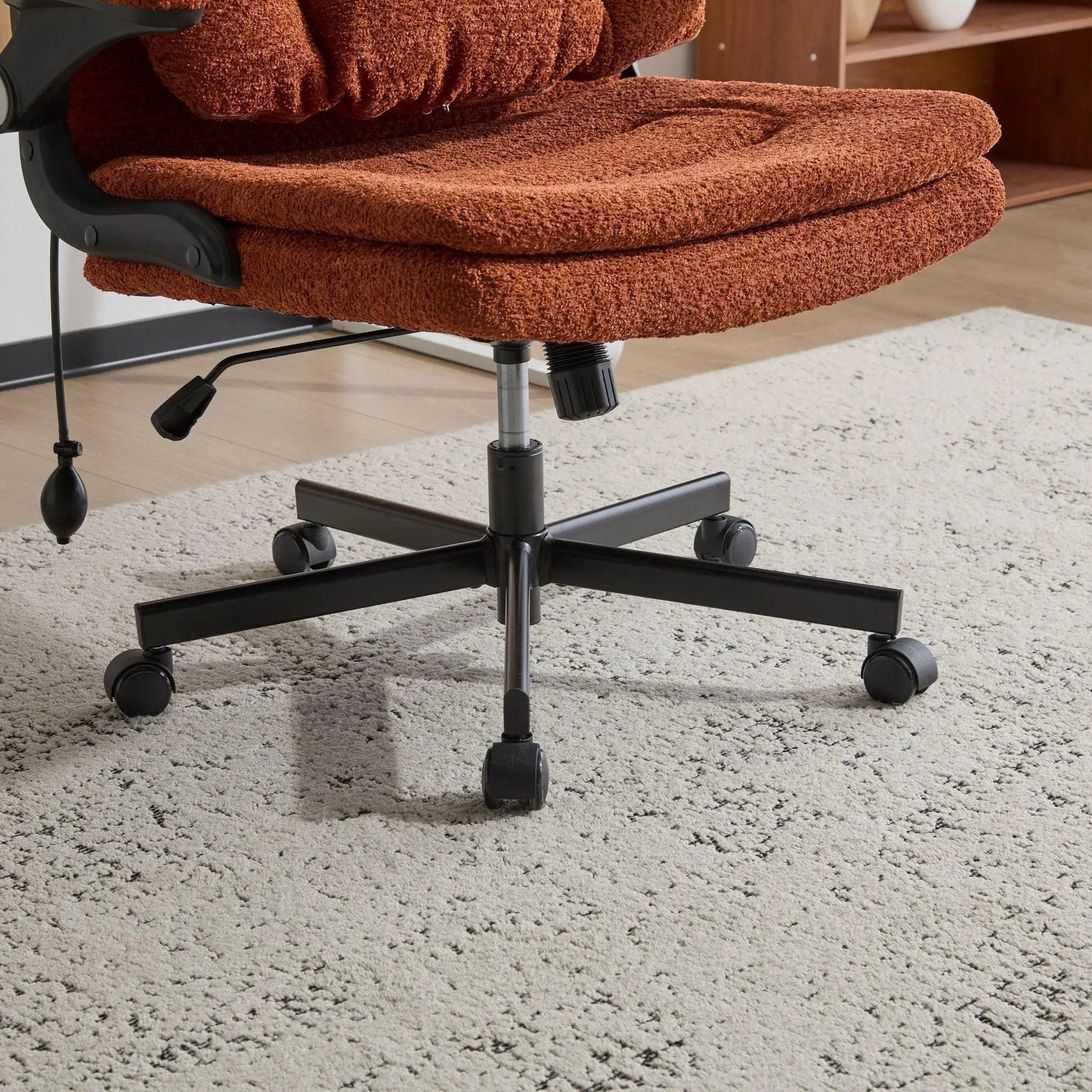Doba orange ergonomic criss-cross desk chair with flip-up back and arms, featuring nylon upholstery and adjustable design.