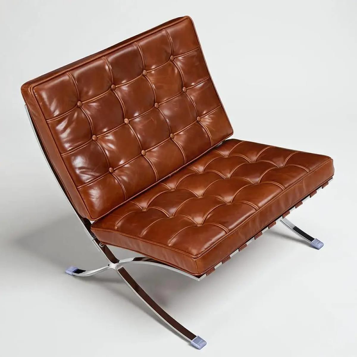 Black foldable lounge chair in Barcelona style with durable frame and non-slip feet from Platinum-Level Office Chairs.