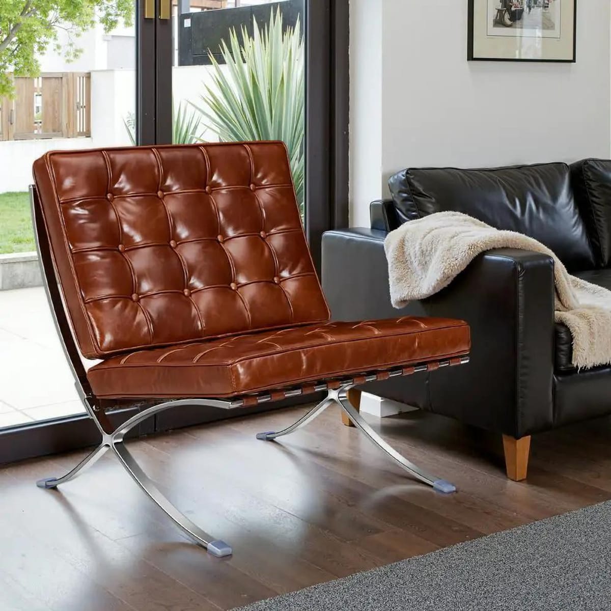 Black foldable lounge chair in Barcelona style with durable frame and non-slip feet, designed for comfortable seating in spaces.