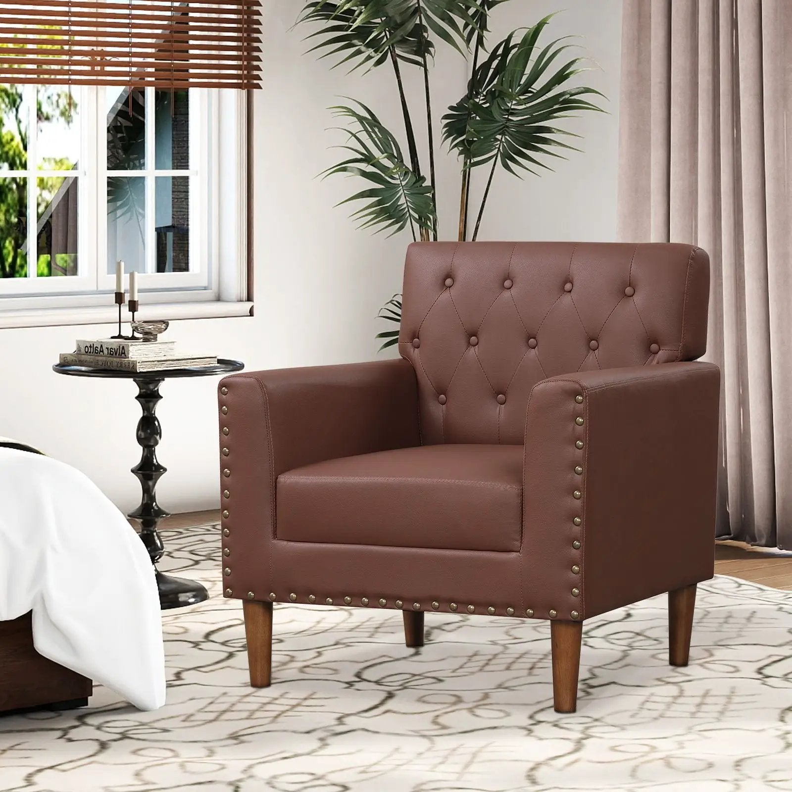 Brown mid-century modern button tufted accent chair by Platinum-Level Office Chairs with rivet details and wooden legs.