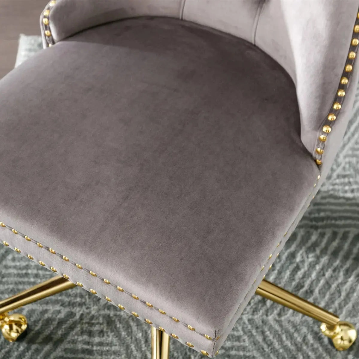Gray velvet tufted executive office chair with ergonomic foam padding and gold metal base by Platinum-Level Office Chairs.