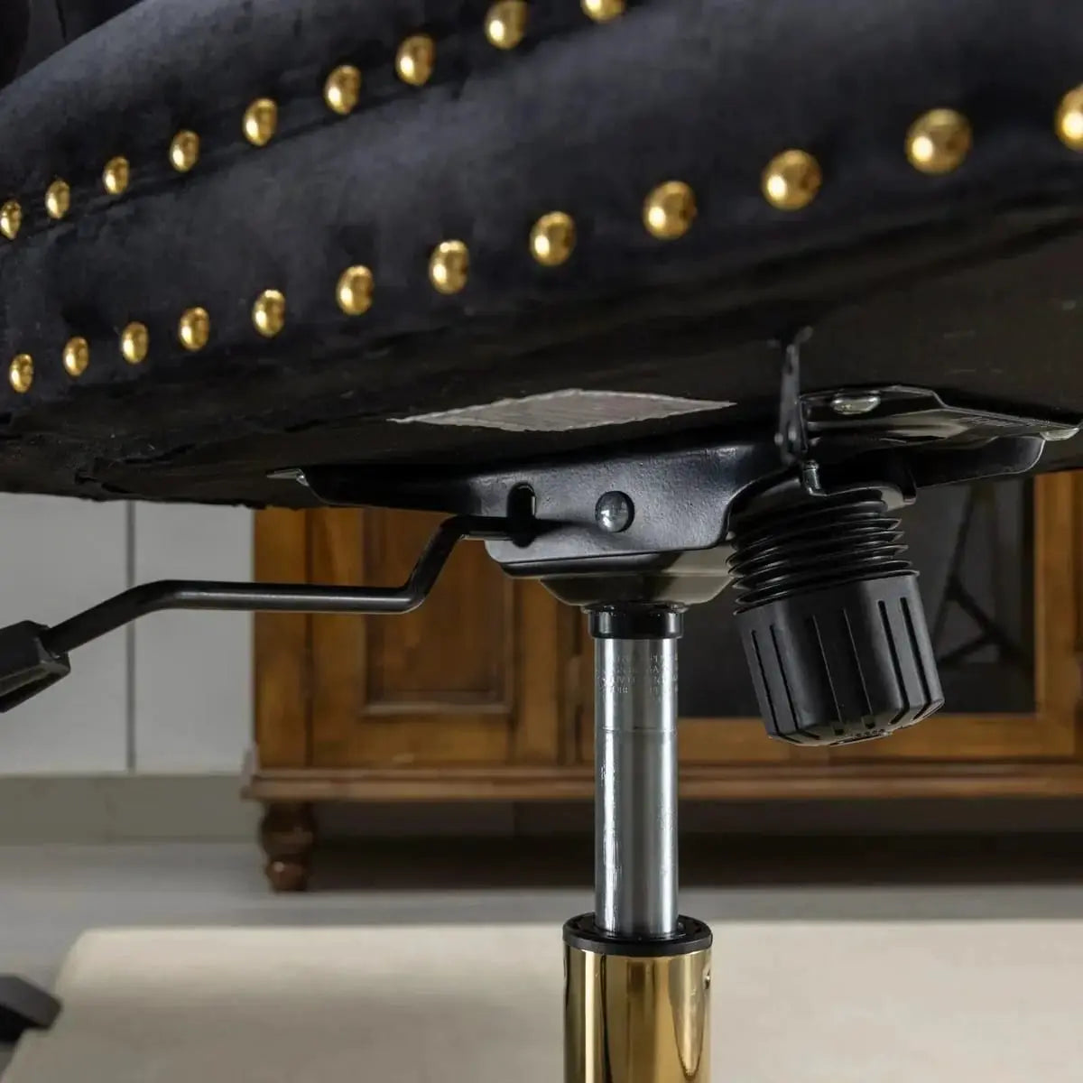 Luxurious black velvet tufted office chair with gold electroplated base, deep seating, ergonomic design, and nailhead trim.