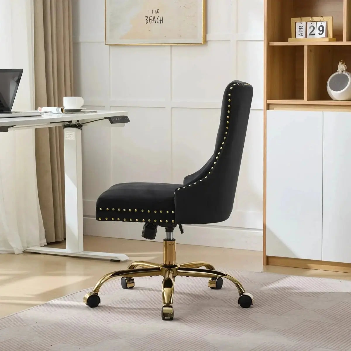 Luxurious black velvet tufted office chair with gold electroplated base, deep seating, ergonomic design, and nailhead trim.