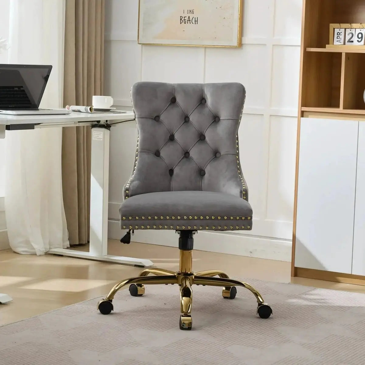 Luxurious gray velvet tufted office chair with gold base, adjustable swivel, and wide deep seat for comfort and style