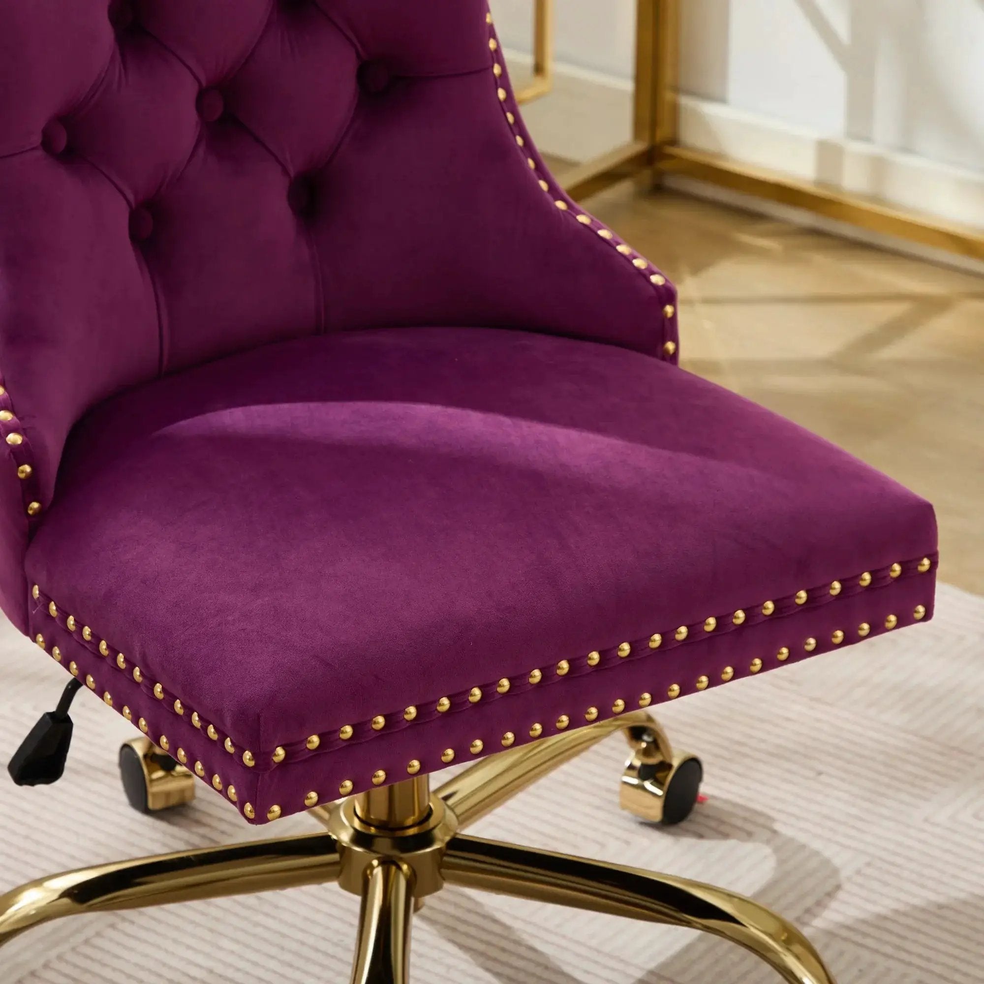 Luxurious purple velvet tufted office chair with gold metal base, nailhead trim, and deep wide seat from Platinum-Level Office Chairs.