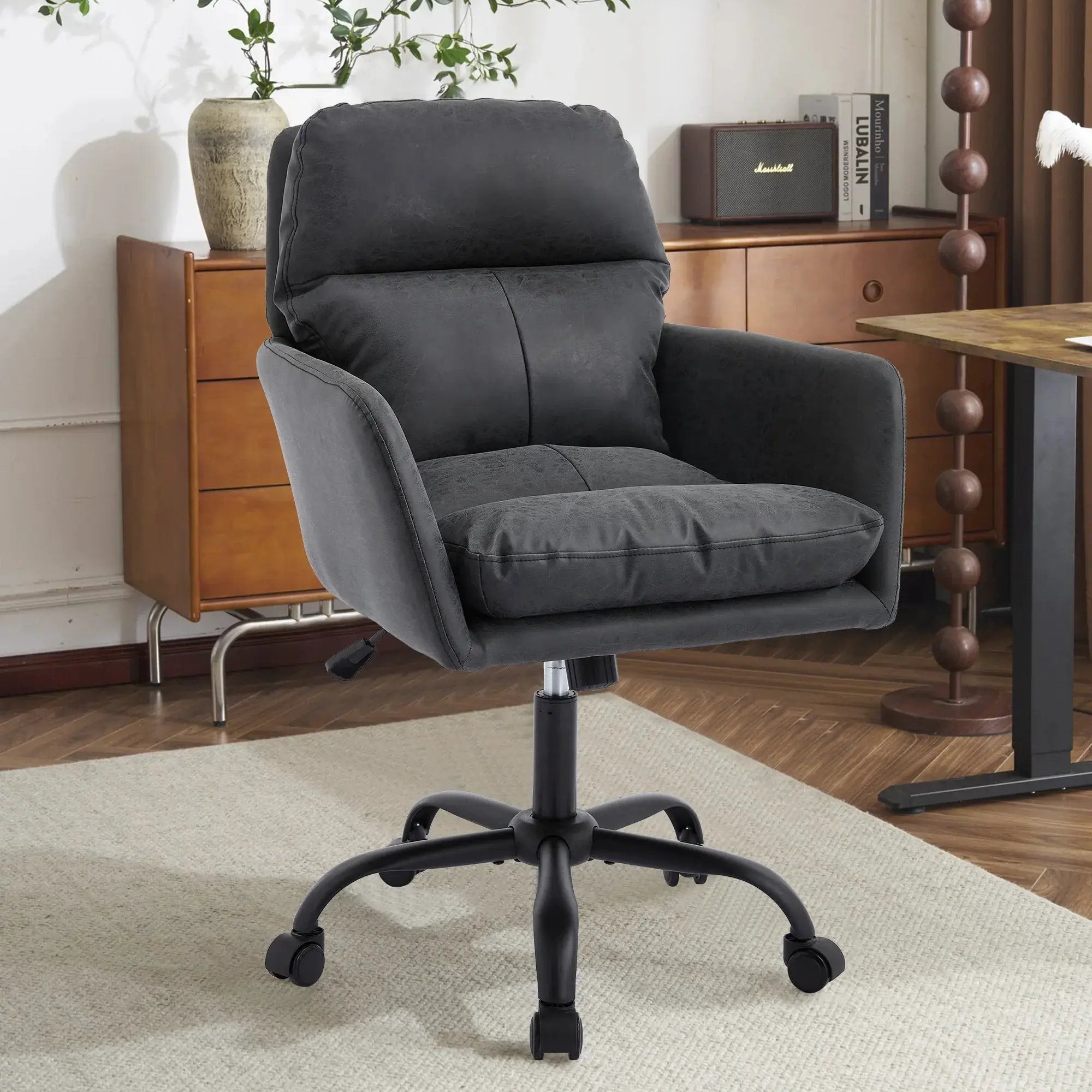 Black leather TY adjustable ergonomic office chair with a durable metal frame, designed for comfort and support.