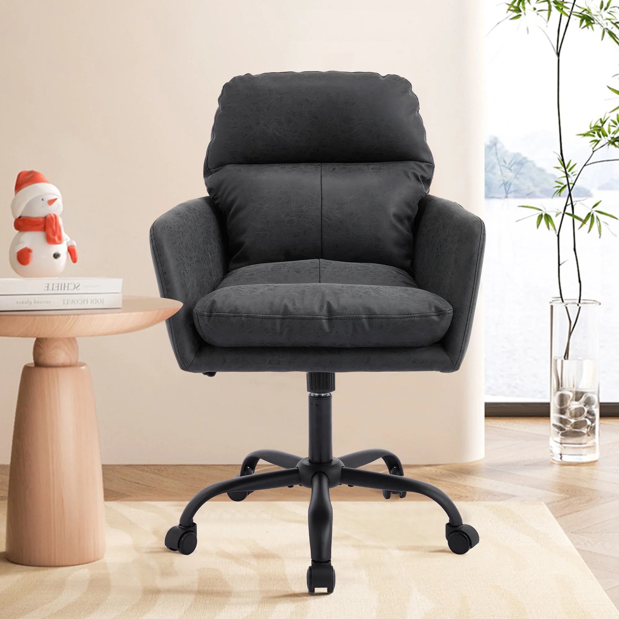 Black leather TY adjustable ergonomic office chair with durable metal frame, designed for comfort and support.